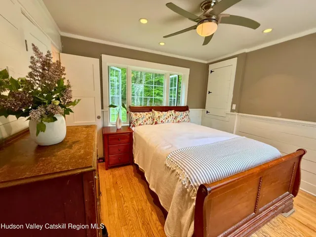 a bed sitting in a bedroom next to a window