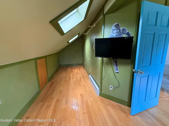 a view of a hallway with wooden floor and stairs
