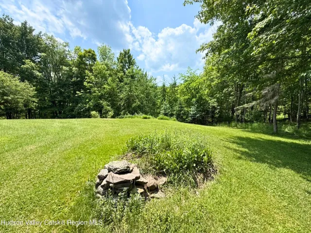 a view of a yard with swimming pool