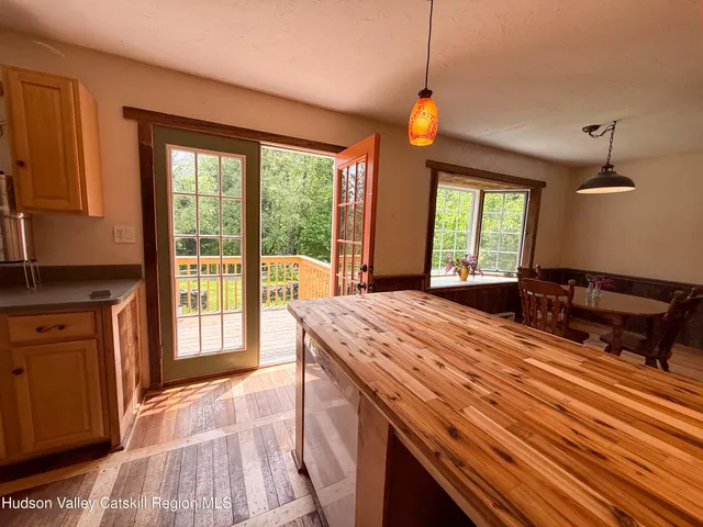 a bedroom with a bed and a dresser next to a window