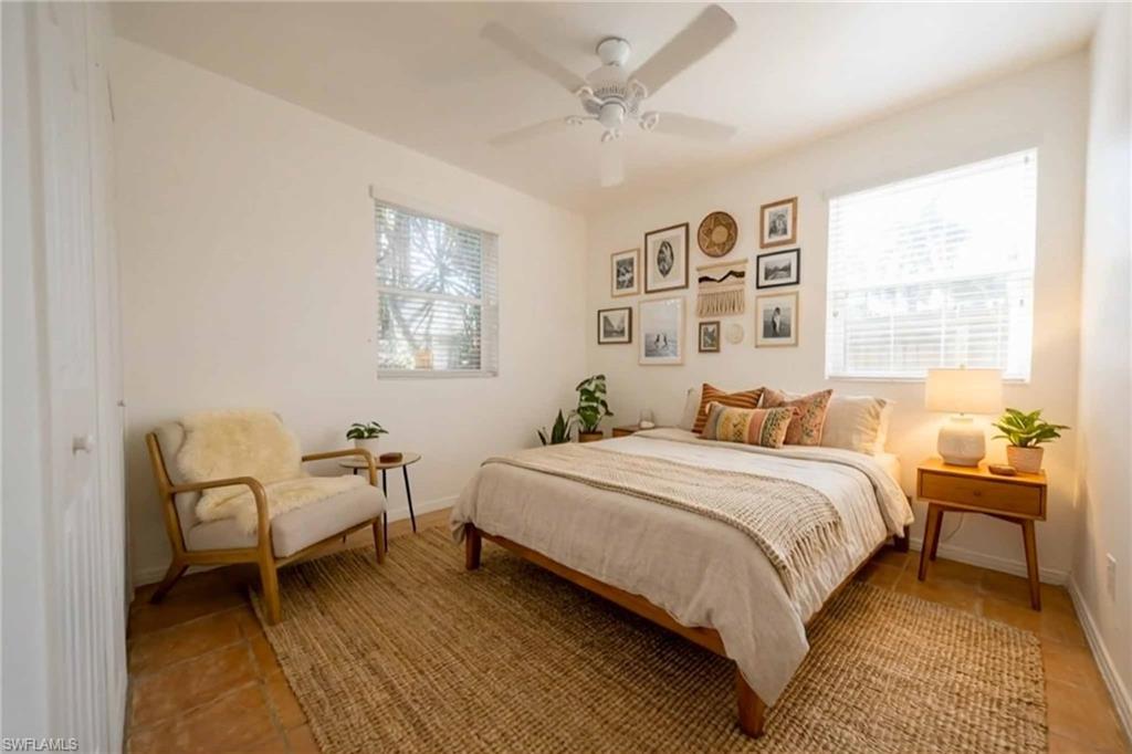 715 10th Street North Naples, FL 34102 - Photo 12 of 36 a bedroom with a bed and a large window