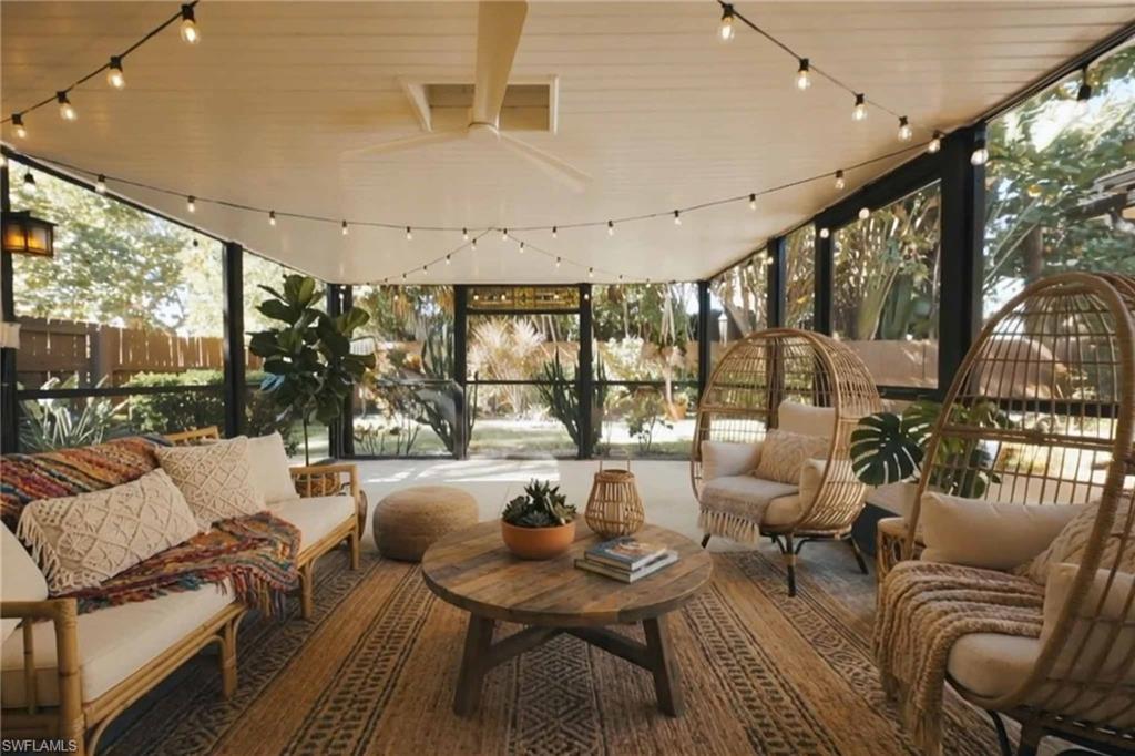 715 10th Street North Naples, FL 34102 - Photo 19 of 36 a living room with furniture and a large window