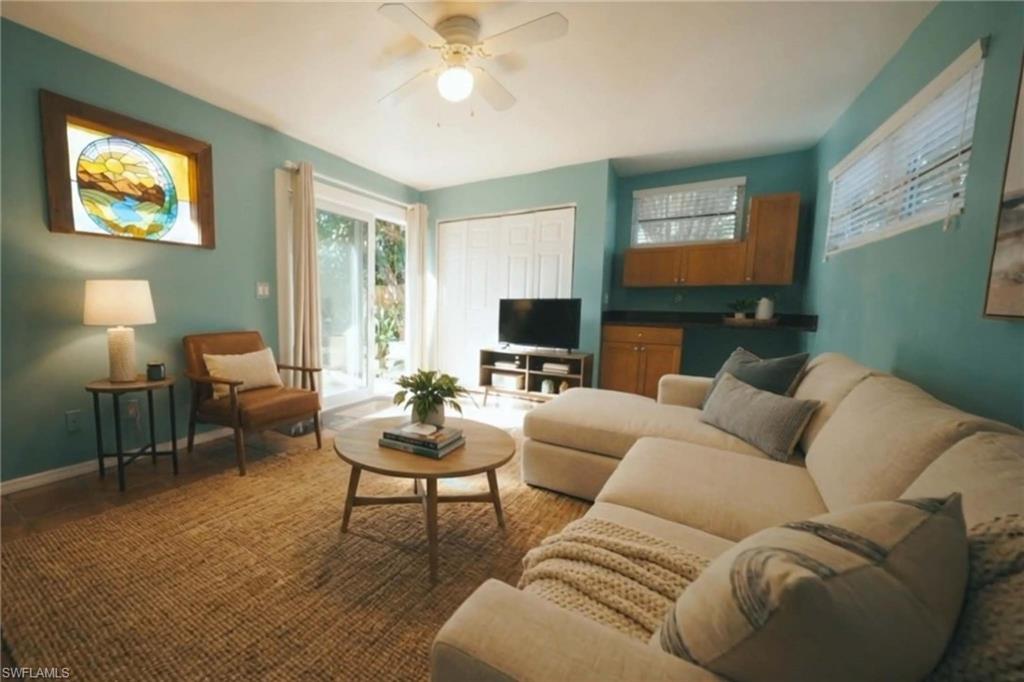 715 10th Street North Naples, FL 34102 - Photo 23 of 36 a living room with furniture and a flat screen tv