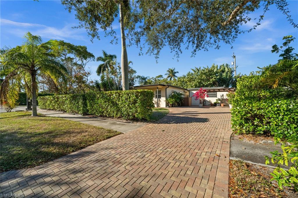 715 10th Street North Naples, FL 34102 - Photo 27 of 36 a view of a yard
