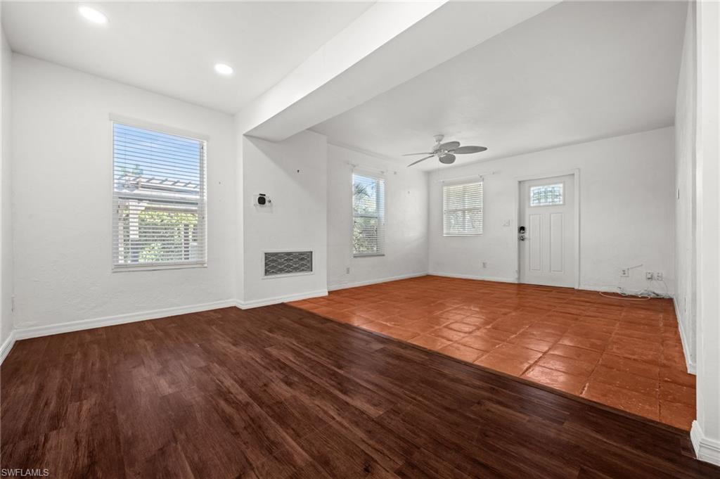 715 10th Street North Naples, FL 34102 - Photo 5 of 36 a view of empty room with wooden floor and fan