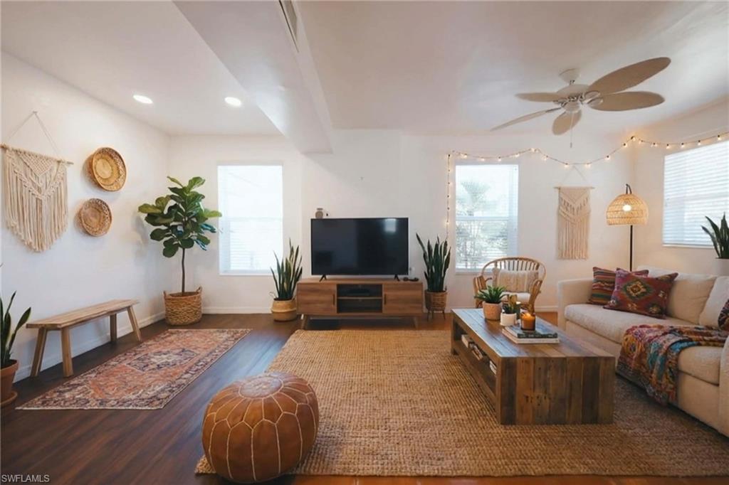 715 10th Street North Naples, FL 34102 - Photo 6 of 36 a living room with furniture and a flat screen tv