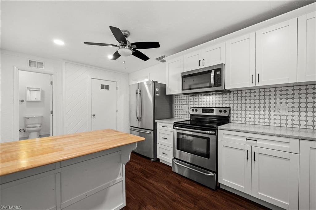 715 10th Street North Naples, FL 34102 - Photo 9 of 36 a kitchen with a sink stove and refrigerator