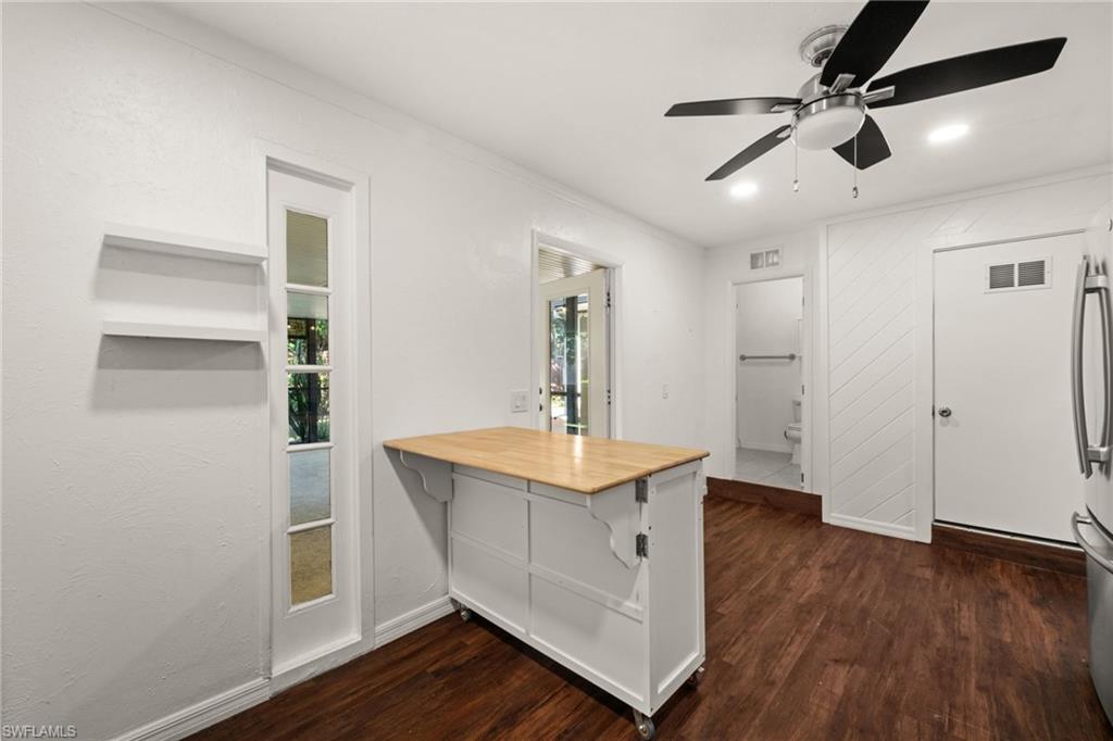 715 10th Street North Naples, FL 34102 - Photo 10 of 36 a view of a room with wooden floor and ceiling fan