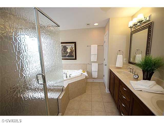 913 Rise Shaft Road Midlothian, VA 23114 - Photo 12 of 24 Master Bath/Spa - The master bath is a wow! the oversized, walk-in shower offers two heads, a separate water closet, tile, his/her sinks and a large, corner jetted tub. Don't forget the bubbles!