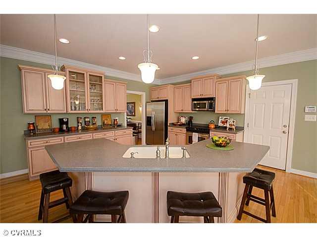 913 Rise Shaft Road Midlothian, VA 23114 - Photo 4 of 24 Kitchen - You will love cooking in this well planned kitchen. Corian counters, huge island, upgraded cabinetry and pulls, stainless appliances, recessed and pendant lights will make cooking a delight!
