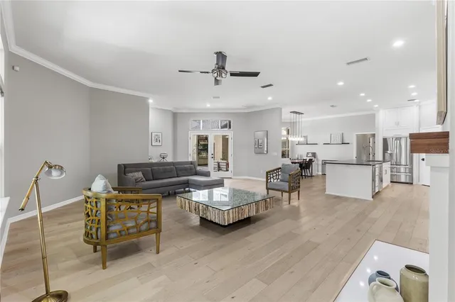 a living room with furniture and kitchen view