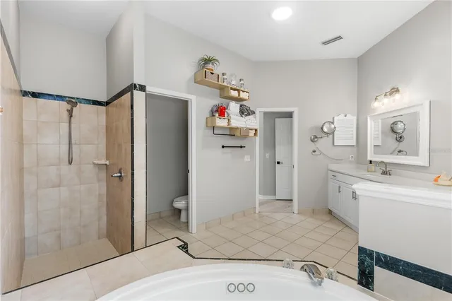 a spacious bathroom with a double vanity sink mirror and shower