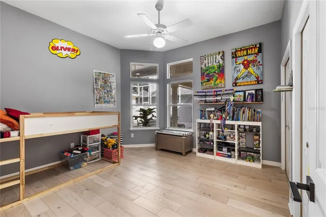 a view of room with toys and ceiling fan