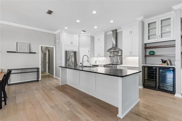 a kitchen with stainless steel appliances granite countertop a stove refrigerator and cabinets