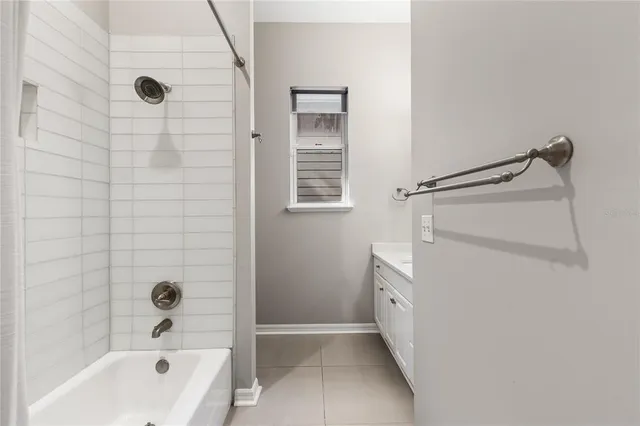 a bathroom with a tub a sink and a shower