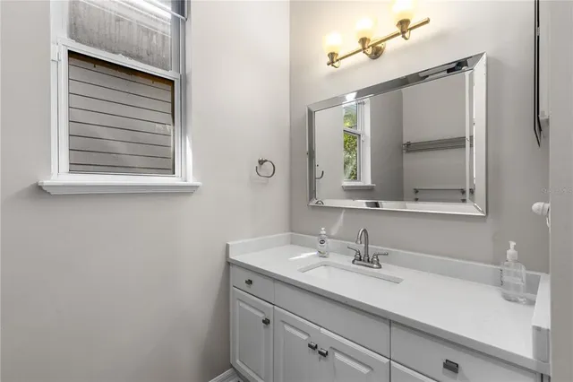 a bathroom with a sink and a mirror