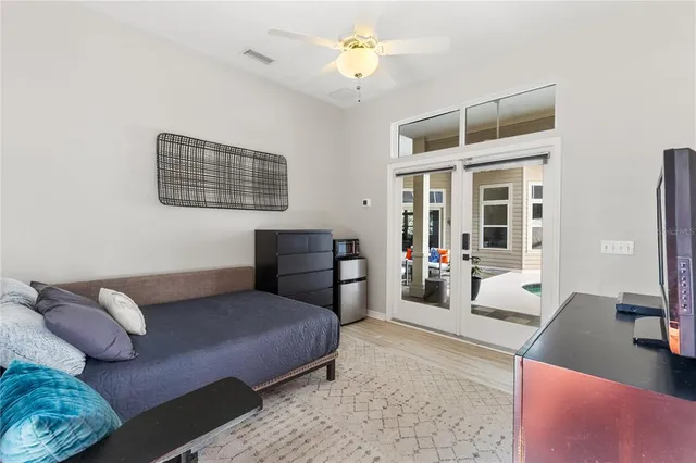 a bedroom with furniture and a chandelier