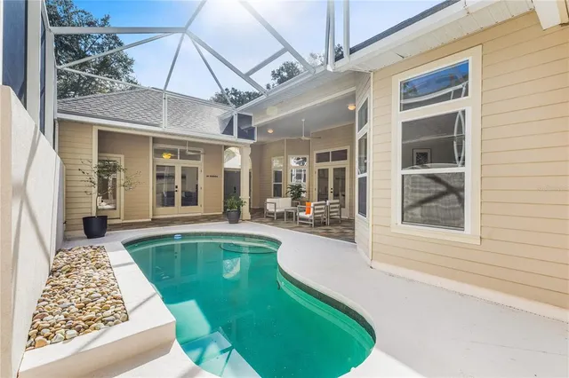 a swimming pool with outdoor seating and yard