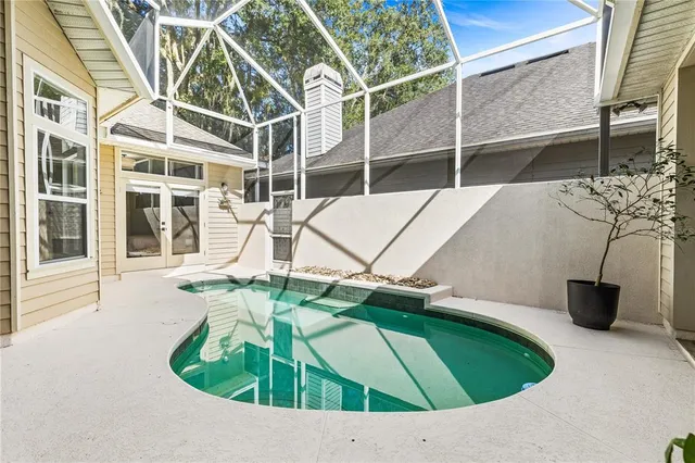 a swimming pool with some potted plants