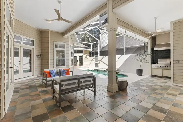 a living room with couches a dining table and a fireplace with wooden floor