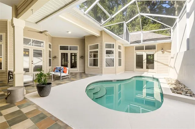 a view of a swimming pool with potted plants