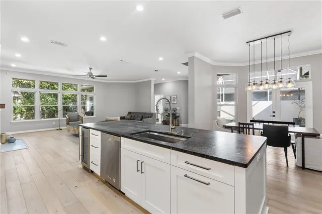 a kitchen with stainless steel appliances granite countertop a sink counter space and wooden floor