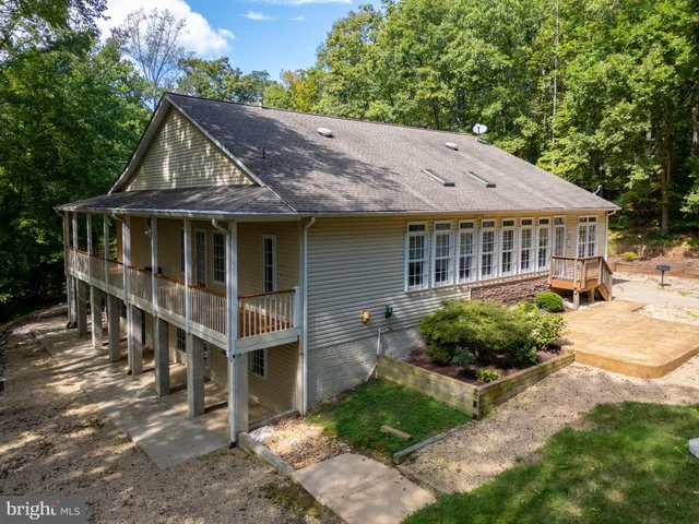 a house with lots of trees in the background
