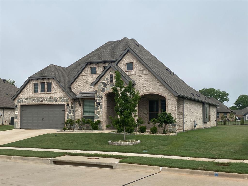 209 Johnson Street Granbury, TX 76048 - Photo 2 of 40 View of front of house featuring a garage and a front lawn