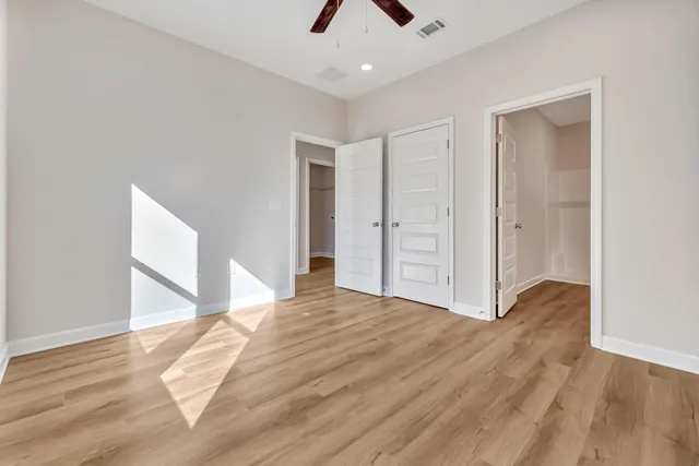 a bathroom with a toilet a sink a mirror and vanity