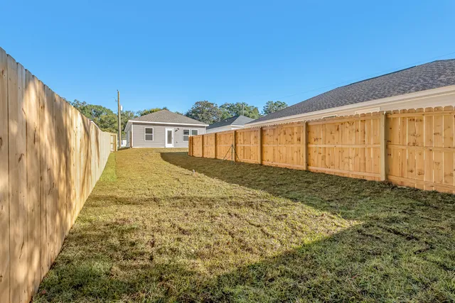 a house view with a backyard space