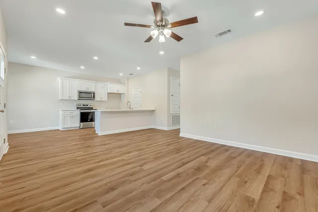 a view of kitchen with granite countertop cabinets and wooden floor