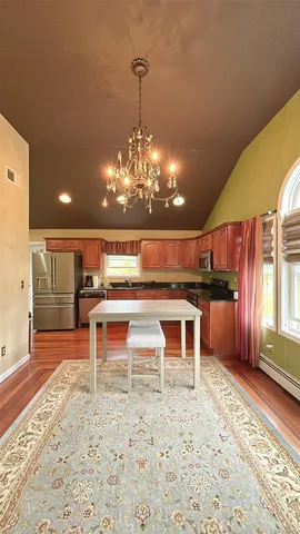 a kitchen with stainless steel appliances kitchen island granite countertop a refrigerator and a stove top oven