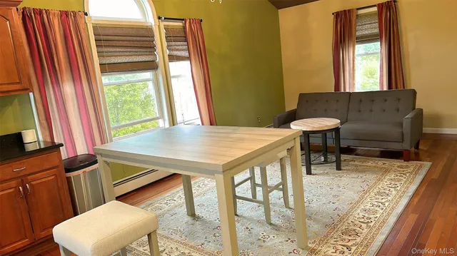 a view of a dining room with furniture and a window