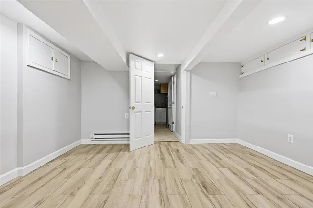 a view of a room with wooden floor