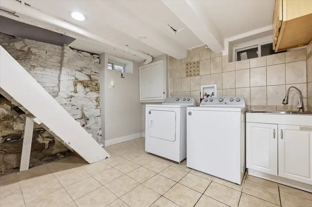 a utility room with cabinets washer and dryer