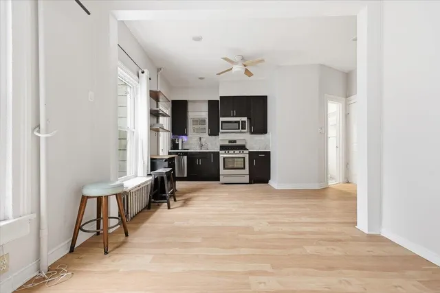 a view of a kitchen with microwave and furniture