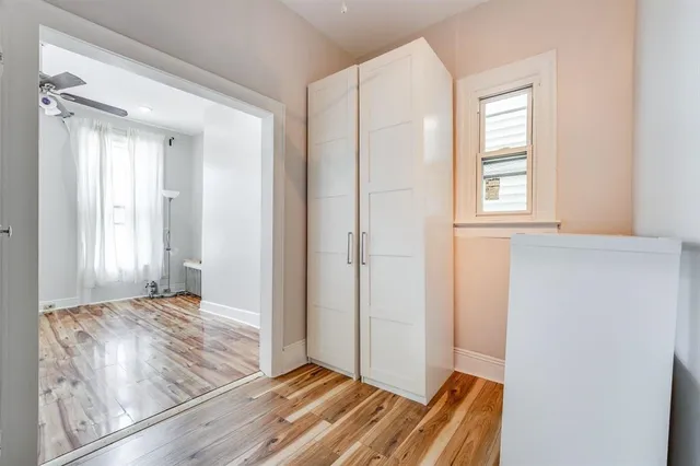 a view of room with window and wooden floor