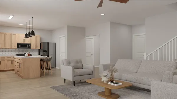 a living room with furniture and a view of kitchen
