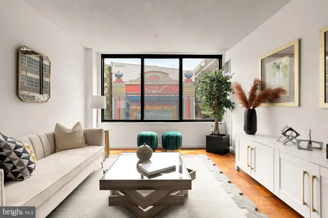 a living room with furniture and next to a window