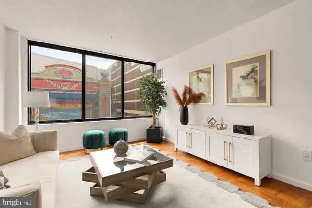 a living room with furniture a lamp and a window