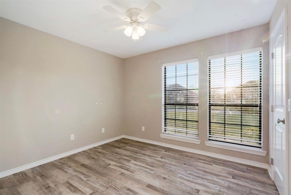 90 44th Street Southwest Paris, TX 75460 - Photo 11 of 17 a view of wooden floor and windows in a room