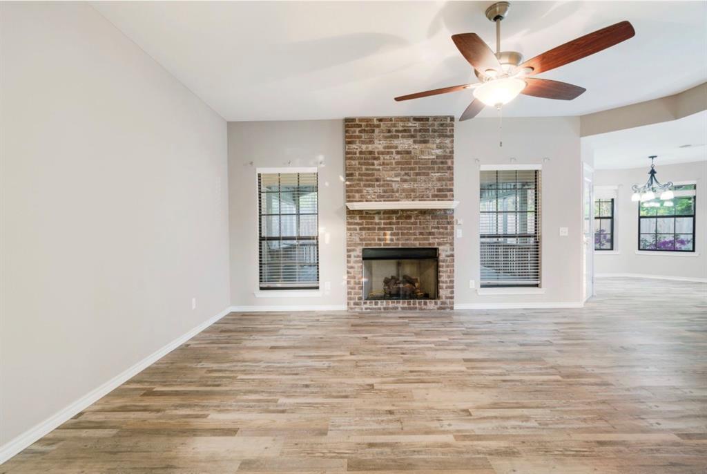 90 44th Street Southwest Paris, TX 75460 - Photo 3 of 17 a view of an empty room with wooden floor fireplace and a window