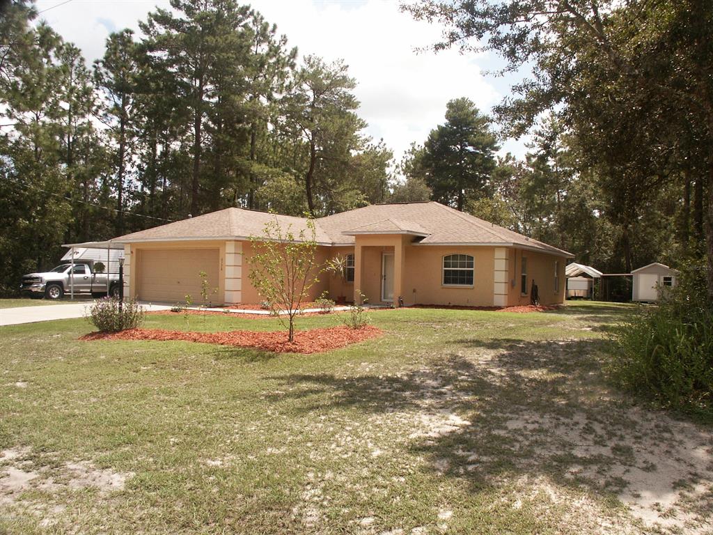 6776 Southwest 153rd Pl Road Ocala, FL 34473 - Photo 1 of 1 a house that has a tree in front of it