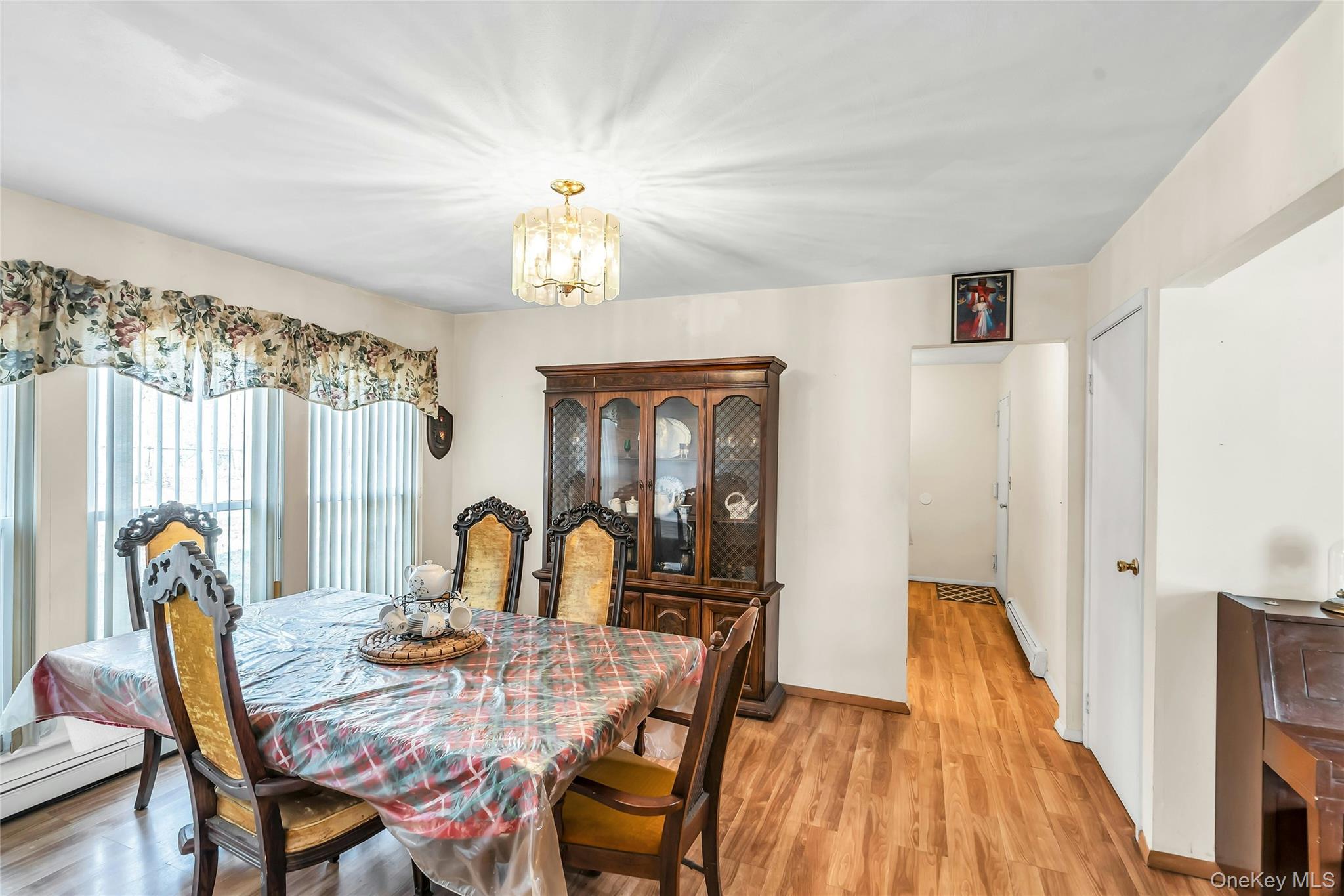 7 Hastings Drive Ridge, NY 11961 - Photo 12 of 33 a view of a dining room with furniture and chandelier