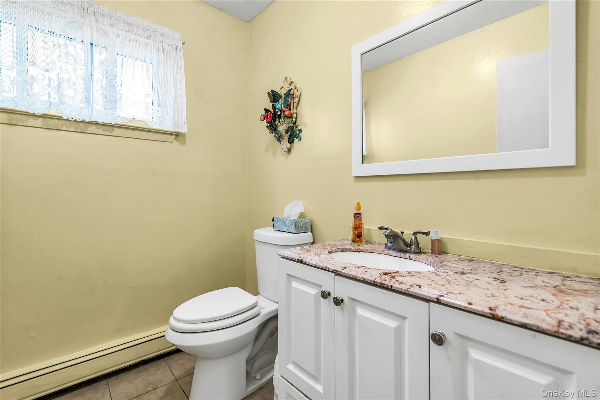7 Hastings Drive Ridge, NY 11961 - Photo 15 of 33 a bathroom with a granite countertop sink and a toilet