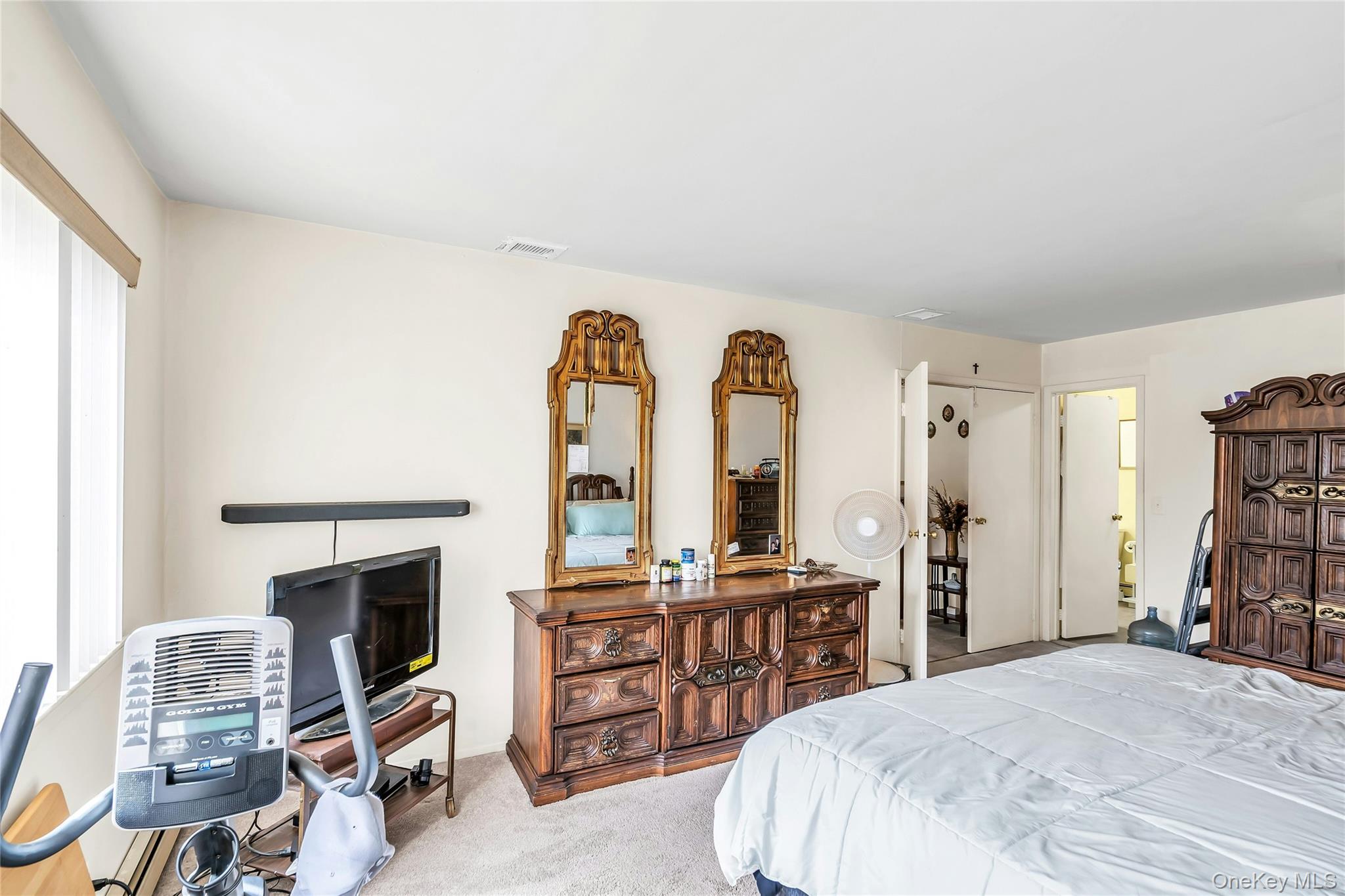 7 Hastings Drive Ridge, NY 11961 - Photo 18 of 33 a bedroom with furniture and a fireplace