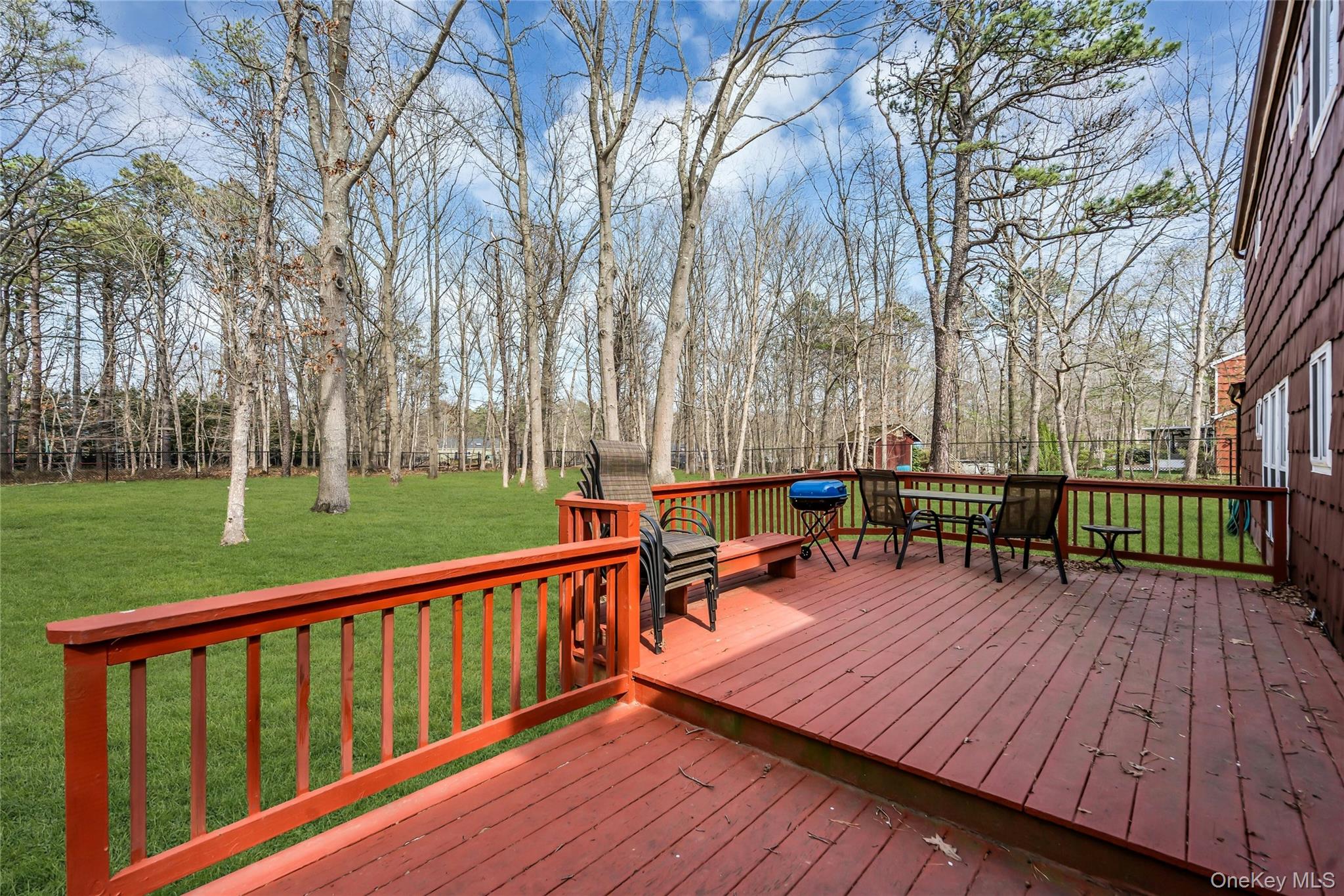 7 Hastings Drive Ridge, NY 11961 - Photo 27 of 33 a balcony with wooden floor outdoor seating and trees