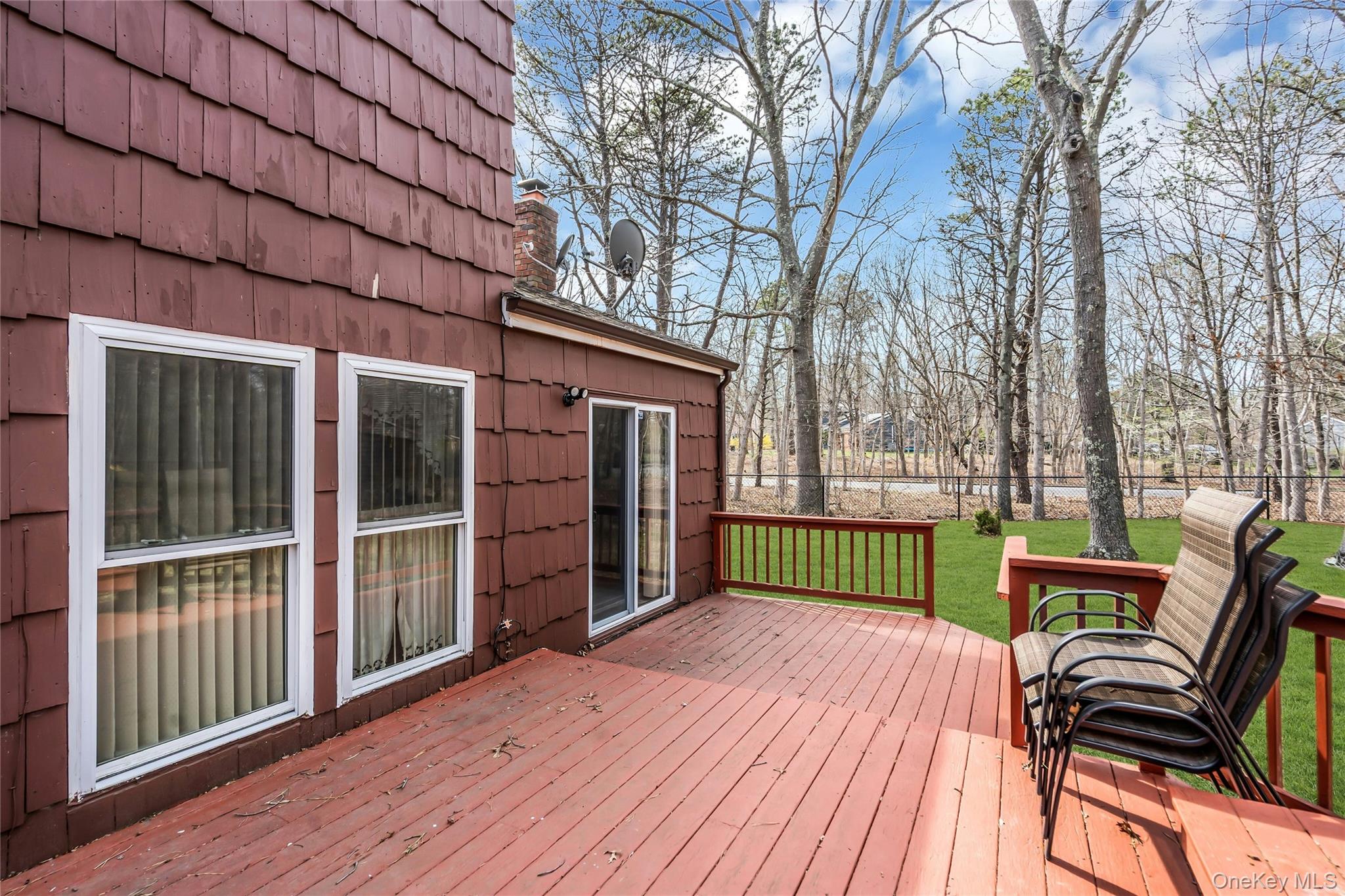 7 Hastings Drive Ridge, NY 11961 - Photo 28 of 33 a view of a house with a wooden deck and a large window