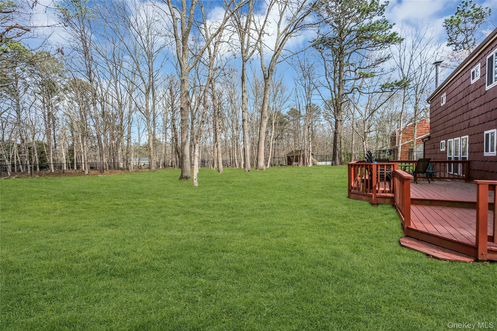 7 Hastings Drive Ridge, NY 11961 - Photo 29 of 33 a backyard of a house with lots of green space and fountain