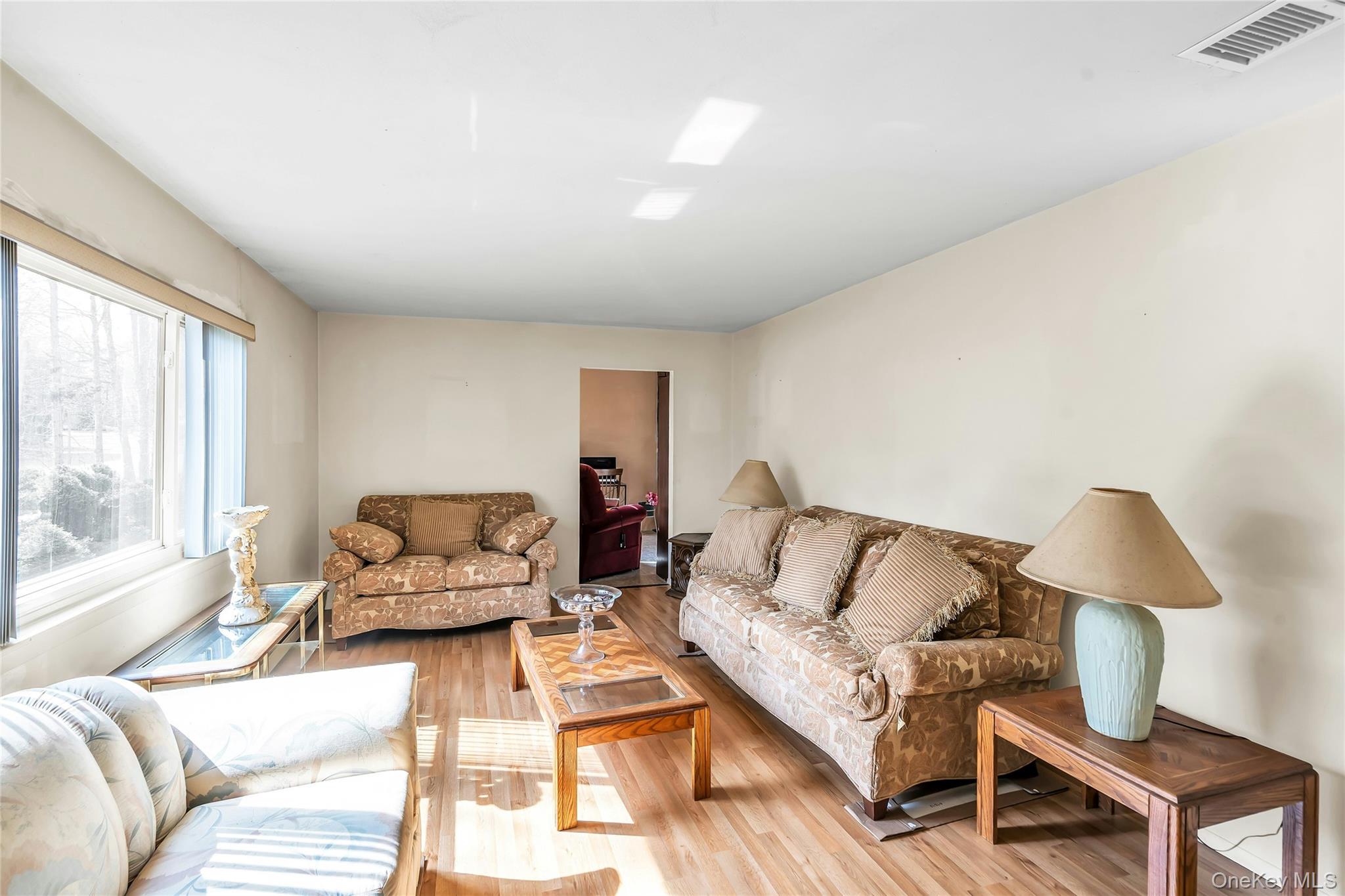 7 Hastings Drive Ridge, NY 11961 - Photo 4 of 33 a living room with furniture and a large window